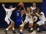 Hancock's  Glen Jordan is blocked by West Hills players Tyler Fields, Dylan Gonzalez, and Bryce Hernandez in Wednesday's 104-66 loss to the visiting Bulldogs.